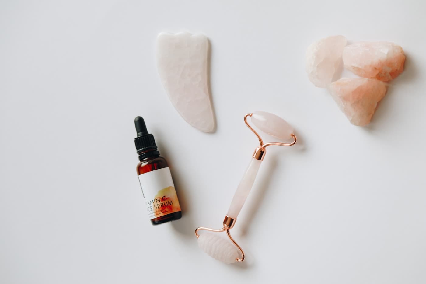 Gua sha, roller and facial oil flat-lay