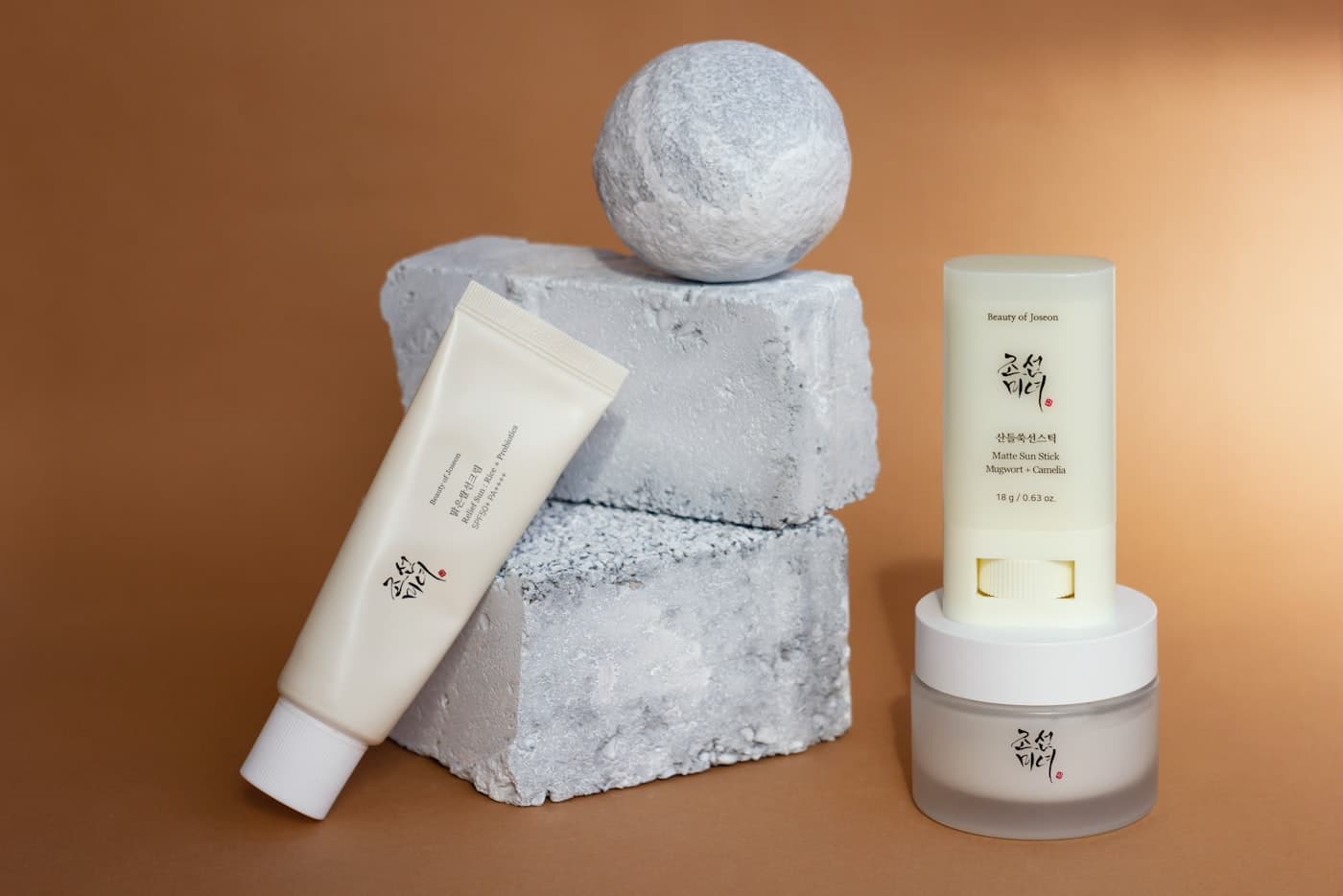 Cream tubes resting on sculptural stone