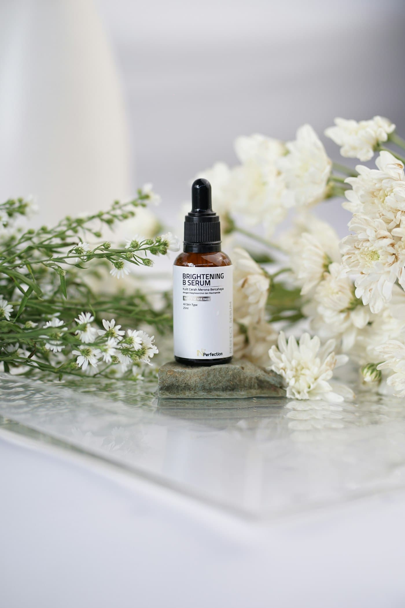GOYO serum bottle among white botanicals